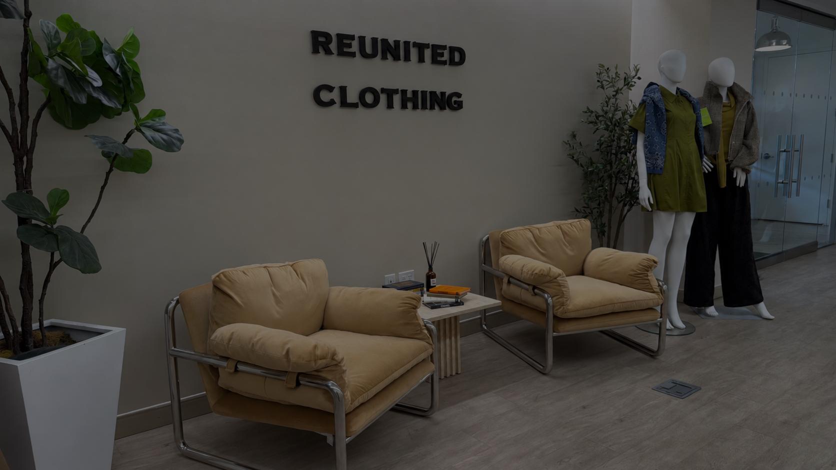 Reunited Clothing office lobby with the company wall sign and dressed mannequins